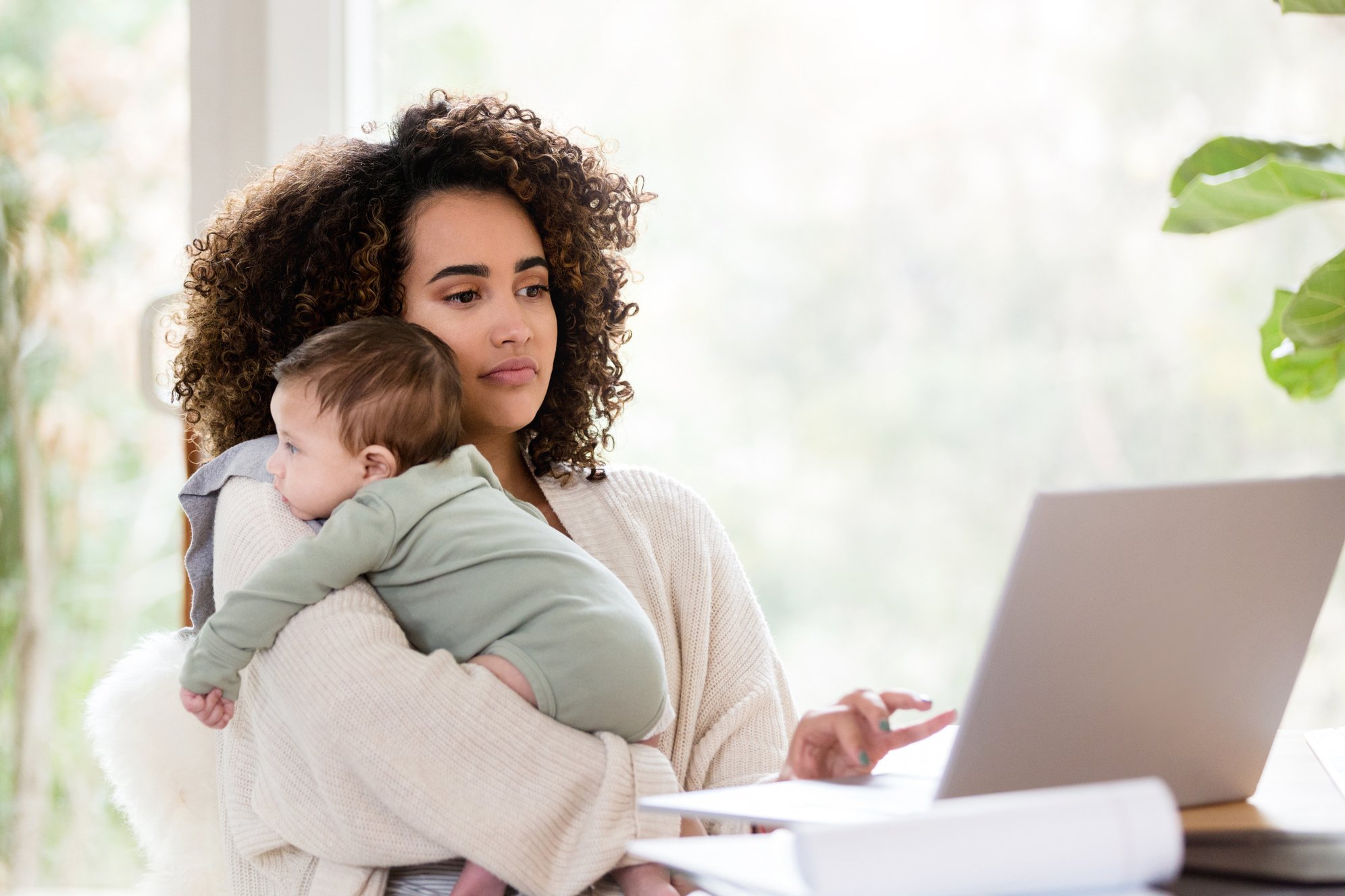 New mom multi-tasks while working remote job